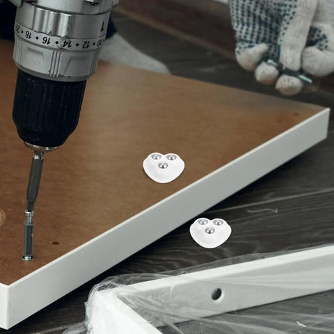Kickstart Your Home Setup With Heavy Duty Peel And Stick Caster Wheels Featuring Stainless Steel Rollers For Furniture And Appliances Smooth Glide Movement Easy Install Durable Glides That Move Your Gear Hassle Free mounted on a wooden board with a drill.