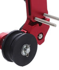 Thinking Process: red aluminum motorcycle chain adjuster with black roller and mounting bolts, close-up