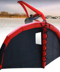 Inflatable Wing Surf Kite For Beginners in red and black, 5 square meters, quick inflate, on a windy day by the water.