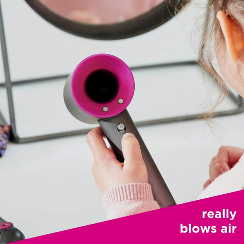 Child holding hair dryer from Supersonic And Corrale Deluxe Styling Set Toy Straightener And Hair Dryer With Real Function For Kids 3 And Up