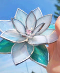 Close-up of Four Layer Stained Glass Succulent Soldering Jig Kit With 3D Flower Bloom held in hand against blue sky.