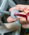 Person using Brake Disc Thickness Measurement Verniers Caliper to check disc thickness on a car wheel.