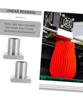 Two plated flange linear bearings (front view) with a red 3D-printed vase on a printer.