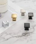 Curved Square Top Cabinet Knob Chrome Pull Handle 25mm Pack Of 25 in various colors displayed on marble surface