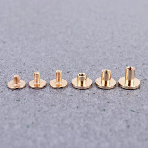 Top Shelf Copper Flat Head Rivet Screws, Thirty Pack Chicago Fasteners, copper fasteners in various sizes laid on fabric.
