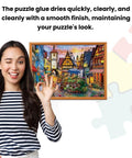 Person gesturing OK next to framed puzzle preserved with Puzzle Glue With Wide Plastic Spreader Easy To Apply Dries Clear And Quick