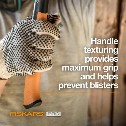 Gloved hand holding IsoCore 20 Oz General Use Hammer With Rip Claw Magnetic Nail Starter And Shock Absorbing Grip For Home Improvement.