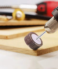 10Pcs Polishing Wheels For Rotary Tools With Brown Corundum Abrasive And Cloth Substrate in use on wooden surface