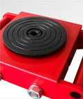 Close-up of Heavy Workhorse Furniture Dolly And Steel Machine Skates With Six Ton Load Capacity Multi Directional Swivel Rollers. Red frame and black roller.
