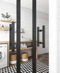12 Inch Square H Shape Barn Door Pull Handle Dual Side Stainless Steel For Glass And Wood Doors Tough As Nails Heavy Duty Sliding Barn Door Shower Door Black Finish Pack Of 2 installed in a modern laundry room setting.