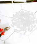 Hella Sturdy Slick Furniture Connector Kit 100 Piece Hidden Fasteners on work surface with pliers and connectors.