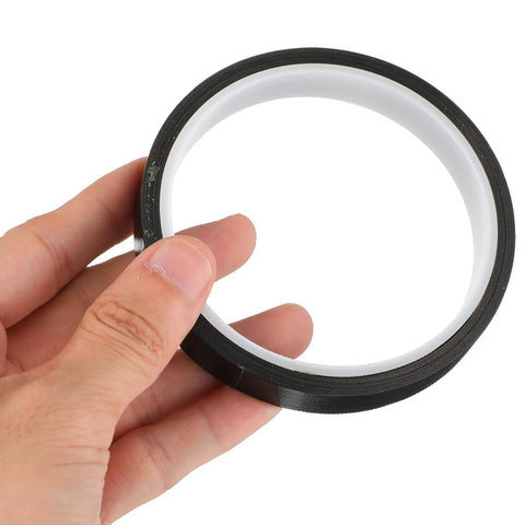 Hand holding High Temperature PTFE Heat Resistant Tape For Heat Transfer Applications, 1 Roll, One Half Inch Wide, 33 Feet Long.