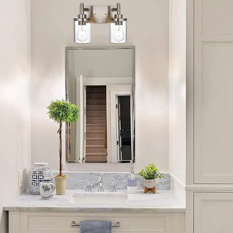 Bathroom with 2-light brushed nickel vanity fixture over mirror, clear glass shades, industrial wall mount for farmhouse decor.