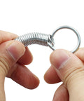 Close-up of stainless steel spring latch hook with ring for pet cage doors