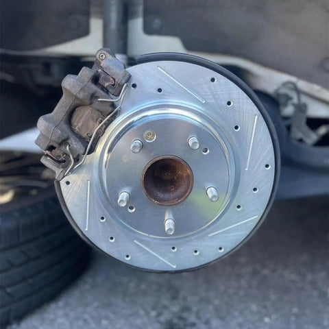 Street Tough M12x1.5 Wheel Studs And 43mm Lug Bolts 5 Piece Kit with brake rotor and caliper on Honda vehicle.