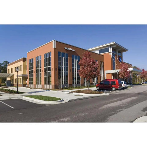 Commercial building exterior with glass windows and red car, potential location for High Output 5,500 Lumen LED Flood Light for Outdoor Use.