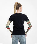 Fresh Retro Garage Mechanic Arm Sleeves With Thumb Holes UPF Sun Block Super Lightweight Cooling Wrap For Golf Weekend Drives And Keeping Arms Straight Up Chill worn from behind by a woman, featuring sleeved tattoos.