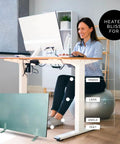 Woman at desk using Legs Flat Panel Heater For Desk Or Wall Mount Ultra Slim One Inch Thick Low Wattage 150W Radiant Heating Space Heater Energy Efficient Cozy Heat For Legs And Feet All Day for warmth