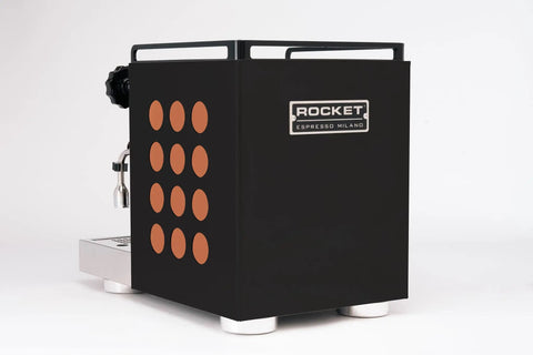 Professional Grade Kickass Heat Exchange Espresso Machine With Longer Steam Wand And Deep Drip Tray Upgraded Glow Interface For Smooth Daily Pulls Black Copper Edition side view showcasing black exterior and orange dot design.