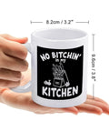 Hand holding No Bitchin' In My Kitchen 11 Oz Ceramic White Mug with Comfortable Handle showing dimensions, funny gift