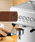 Automatic Home Coffee Machine With Built In Grinder And Steam Milk Frother grinding coffee beans into portafilter