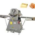 Heavy-Duty 20 Inch Dough Sheeter Machine With Reversible Roller And Adjustable Thickness Control From One To Fifty Millimeters, side view with dough and croissant.