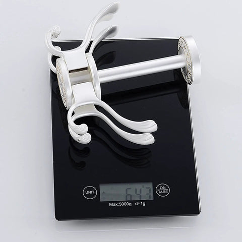 Straight Up Solid Wall Mounted Coat Rack With Five Rotating Metal Hooks on a scale, demonstrating 0.64 kg weight, premium gold and white design.