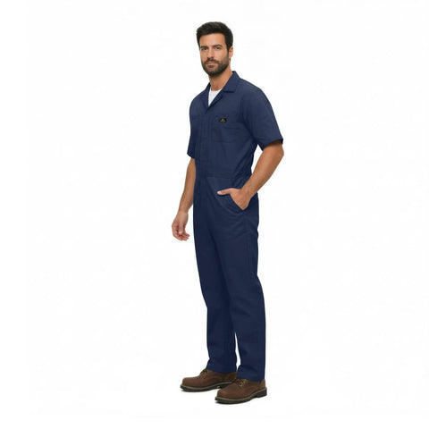 Essential Men's Short Sleeve Zip Up Coverall in Navy Blue, durable poly cotton blend, worn by a man standing.