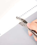 Circle Shaped Handheld Paper Hole Punch, 1/8 Inch Single Hole Punch in use on paper sheet