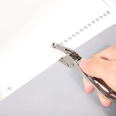Circle Shaped Handheld Paper Hole Punch, 1/8 Inch Single Hole Punch in use on paper sheet