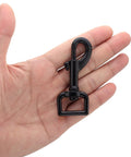 Top Tier Hella Sturdy Black Swivel Eye Bolt Snap Hook held in hand, showcasing zinc alloy build for pet gear.