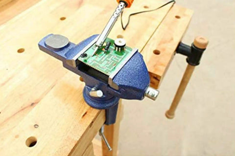 360 Degree Rotating Bench Vise For Woodworking And DIY, 2.5 Inch Cast Iron Table Vise Clamp, Heavy Duty Grip With 0 To 2.5 Inch Jaw Opening, Built Tough For Hobbyists And Makers, clamping a circuit board on a wooden workbench