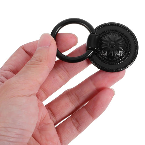 Hand holding a Vintage Style Drawer Pull from set of 4 Retro Flower Cabinet Handles, 36mm black antique dresser hardware for cabinets.