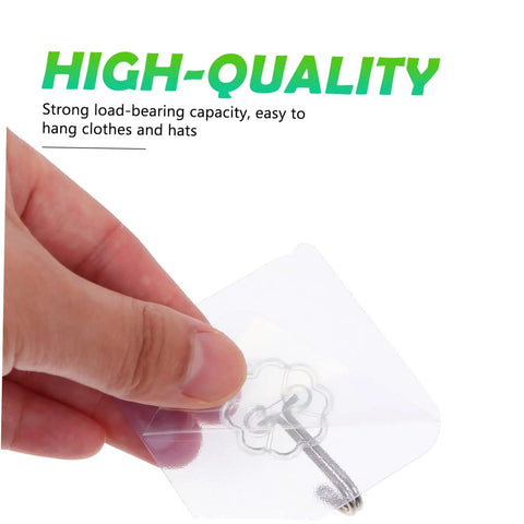 Hand holding a heavy duty adhesive hook set that stays rock solid for easy hanging of clothes and hats in white farm style.