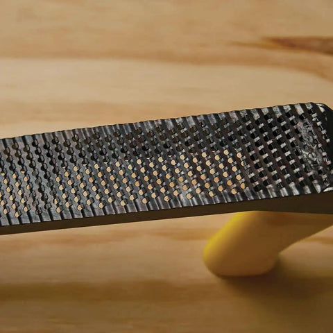 Close-up of a Metal Body Surform Plane For Precision Shaping And Smoothing, 11.8 Inch Hand Tool With Interchangeable Blades on wood