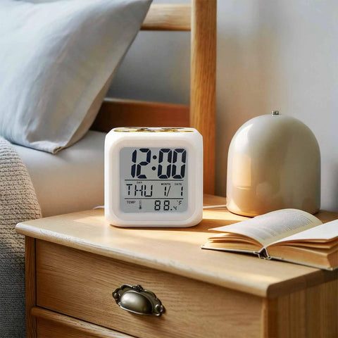 Solid Silent Digital Alarm Clock Featuring Gentle Snooze And Soft Glow Nightlight Shows Time Date And Indoor Temp on bedside table.
