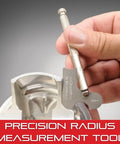 Hand using Small Steel Rule With Holder In Protective Case For Tight Spots Professional Grade Precision Measuring Tool on metal surface