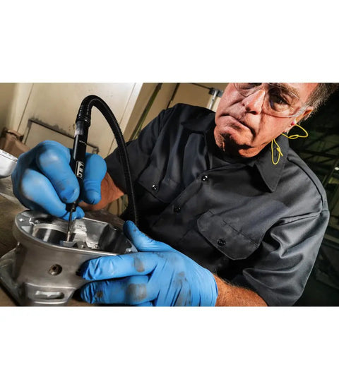 Badass Lightweight Pneumatic Micro Die Grinder With Variable Throttle Reaching 70000 Rpm used for precise grinding on metal surface by mechanic.