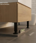 Adjustable Telescopic Under Cabinet Leg with Steel Foot leveling furniture on uneven tiled floor, matte black finish