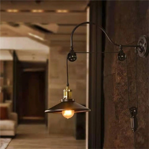 Adjustable Iron Wall Sconce With Smooth Glide Pulley Wheel And Clear Glass Shade For Soft Cozy Ceiling Lighting showcases a bronze bulb-covered fixture.