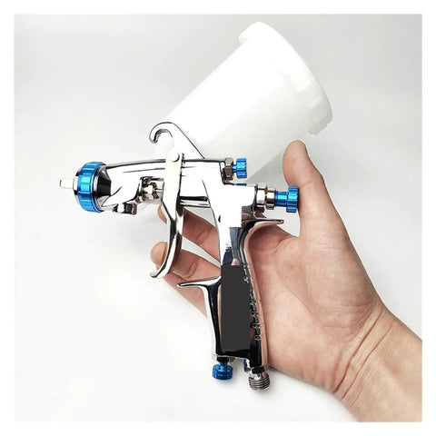Heavy Duty Pneumatic Paint Sprayer With 400Cc Metal And Plastic Cups For Cars And Trucks Includes 1.3Mm And 1.8Mm Nozzles in hand.