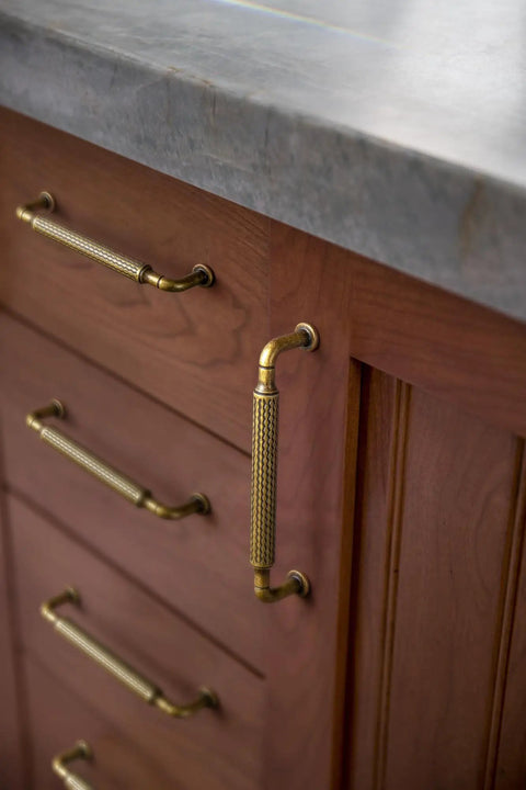 Antique Brass Cabinet Pulls Set, Solid Zinc Alloy Drawer Handles on a brown drawer, 3.8 inch center to center, 6 pack