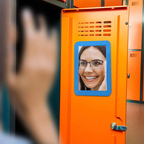 Magnetic Real Glass Mirror 5x7 Inch White Framed Locker Accessory on an orange locker showing a reflection of a woman's face.