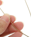 Hand holding a Top Tier Copper Welding Rods Kit 4pcs for Jewelry Making Golden Metal Sticks Soldering Wire.