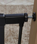 Close-up of 29 Inch High Walk Through Pressure Mounted Steel Dog Gate Expands From 29 To 38 Inches Wide with mounting detail on textured graphite
