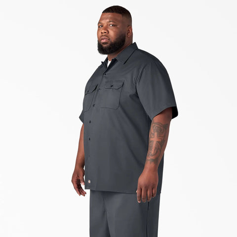 Badass Men Short Sleeve Utility Button Down Workshirt In Charcoal, worn by a man, featuring relaxed fit and utility pockets.