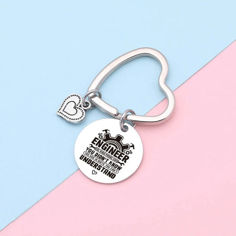 Engraved stainless steel keychain with heart charm "Engineer You Didn't Know You Couldn't Understand" on pink and blue background