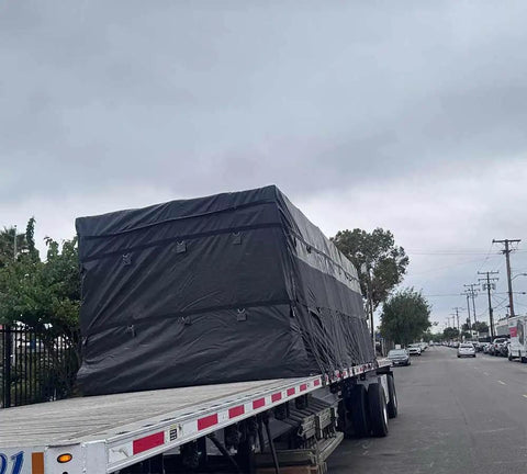 Flatbed truck with tarps secured by 50 Pack 31 Inch Natural Rubber Tarp Bungee Straps With Crimped S Hooks Made From Galvanized Steel Heavy Duty Tie Down Cords For Securing Tarps On Trucks Trailers And Worksites.