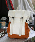Go To Lightweight Waterproof Backpack For Everyday Adventure, large capacity white and orange daypack on outdoor table
