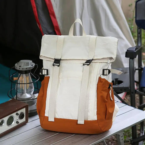 Go To Lightweight Waterproof Backpack For Everyday Adventure, large capacity white and orange daypack on outdoor table